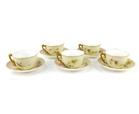 A Royal Worcester old Ivory part tea set, circa 1894, comprising five cups and saucers with coloured and gilt floral decorati