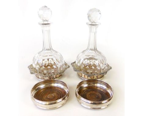 A pair of old Sheffield plate style wine coasters heavy scrolling rim, turned wooden base with central white metal button, to