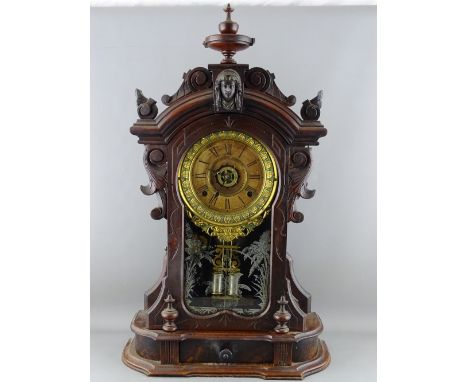 A 19th CENTURY WALNUT CASED ANSONIA MANTEL CLOCK with lower central drawer, 63 cms high overall