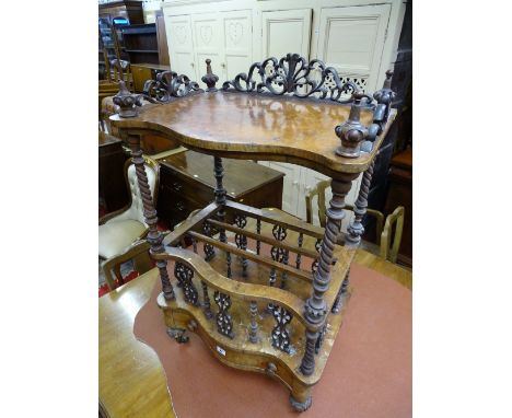 A WALNUT CANTERBURY WHATNOT having a shaped upper shelf with bobbin and carved gallery etc and having barley twist columns to