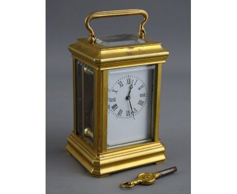 A FRENCH MINIATURE BRASS CASED CARRIAGE CLOCK having a white enamel dial set with Roman numerals, the backplate numbered 3012