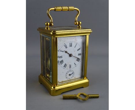 AN E G L, PARIS BRASS CASED ALARM CARRIAGE CLOCK, the white dial set with Roman numerals and subsidiary alarm, stamped backpl