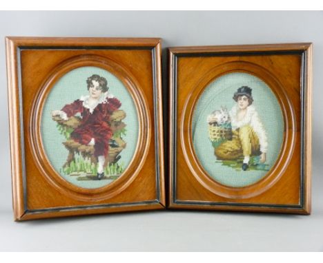 TWO MAHOGANY & EBONIZED PORTRAIT FRAMES containing woolwork oval pictures of young boys, 35 and 36 cms high