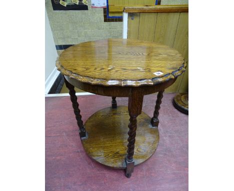 A BARLEY TWIST OAK SIDE TABLE with piecrust top and circular under tier shelf, 74 cms high, 63 cms diameter top