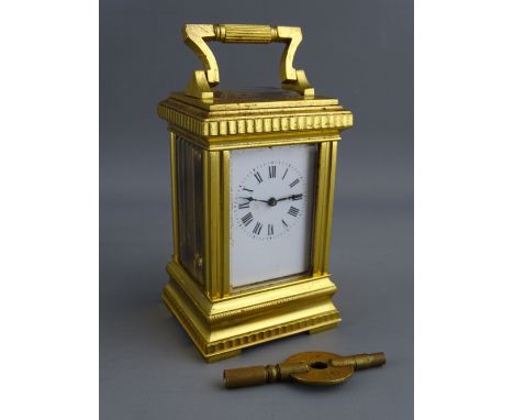 A FRENCH GILT BRASS CASED MINIATURE CARRIAGE CLOCK with white enamel dial set with Roman numerals, the backplate numbered 149