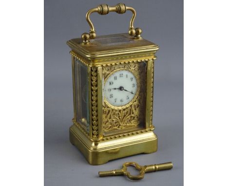 A FRENCH MINIATURE BRASS CASED CARRIAGE CLOCK, the case with pierced leaf canted corners, phoenix decorated pierced brass mas