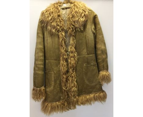 A 1960s Sheepskin Afghan coat. Pen marks to front. Light tan colour with blonde collar, cuffs and hem. 