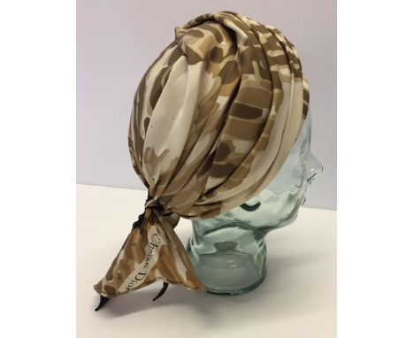 A Christian Dior Chapeaux turban style hat together with a vintage 1950s day hat with veil. Small holes to Christian Dior tur