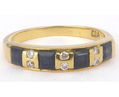 A 9ct gold sapphire and diamond ring, the four square cut sapphires separated by three rows of two tiny diamonds, size M, app