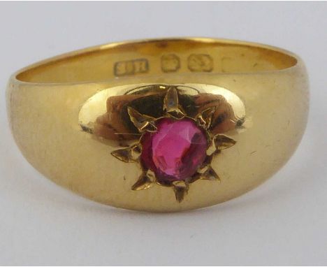 A 22ct gold ring with a small cut ruby in a star mount, size O, approx. 3.3g.