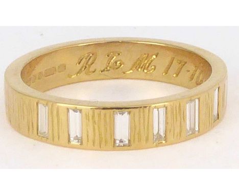 An 18ct gold half eternity ring, the Gypsy set seven vertical baguettes approx. 0.05ct each, total approx. 0.35ct, on a textu