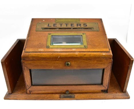 A 19th century brass mounted oak letter and telegram box, the front slope with black heightened letter slot above a front pan