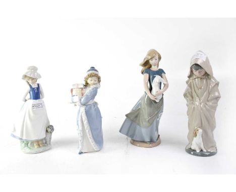 NAO; four porcelain figures comprising a girl with Winter coat and presents, girl with Summer dress and white rabbit, boy wit