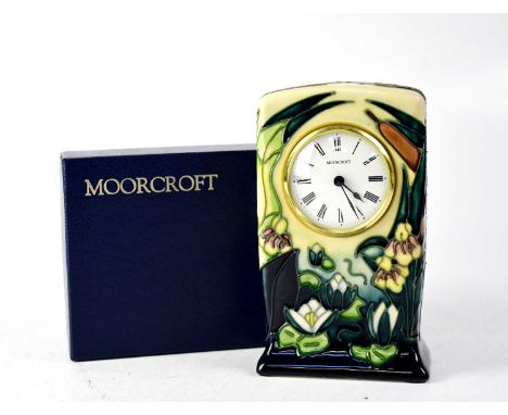 MOORCROFT; a mantel clock with green and blue drip glaze, tube lined 'Water Lilies and Bulrush' pattern, the white dial set w