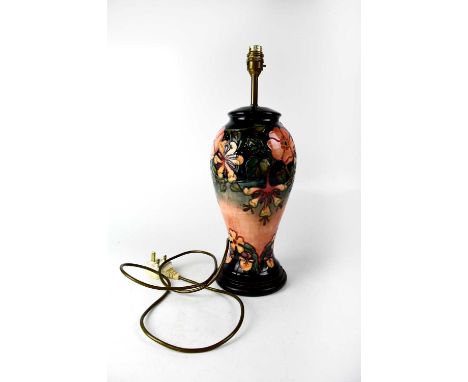 MOORCROFT; a large baluster lamp with tube lined 'Honeysuckle' pattern, on circular stepped base, height 32cm.