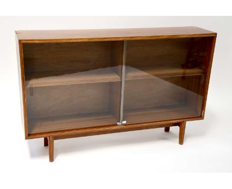 BEAVER &amp; TAPLEY LTD; a mid-20th century teak glazed bookcase with pair of sliding doors enclosing a single shelf, raised 