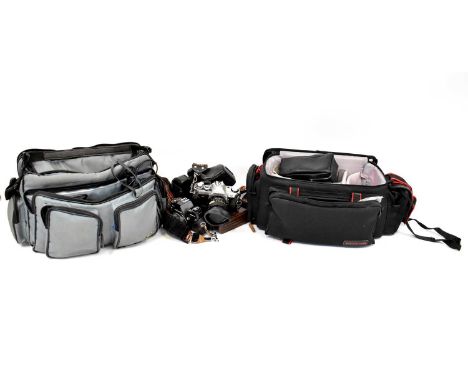 A collection of cameras, lenses and accessories to include a Canon AE-1, a Praktica BC1 Electronic, a Sigma Zoom-K 1:4.5 f=10