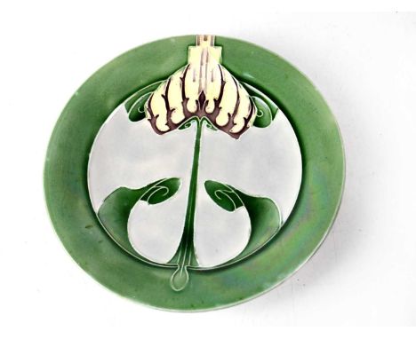 MINTONS; a Secessionist plate with stylised flower within a green border, impressed mark to the base, diameter 23cm.Condition