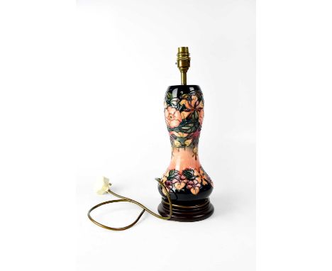 MOORCROFT; a waisted baluster lamp in tube lined 'Honeysuckle' pattern, to circular stepped base, height 26.5cm.