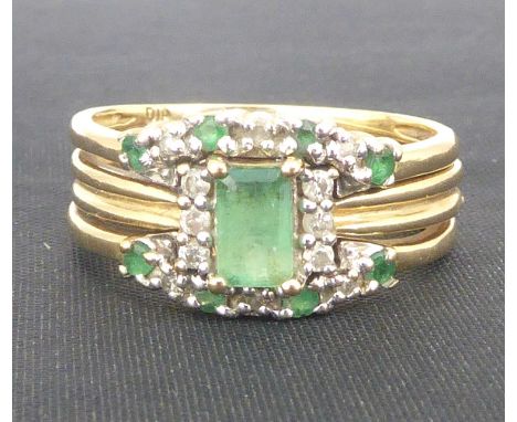 A vintage diamond and emerald bridal set ring, the central emerald cut stone flanked by three tiny diamonds, size K, approx. 