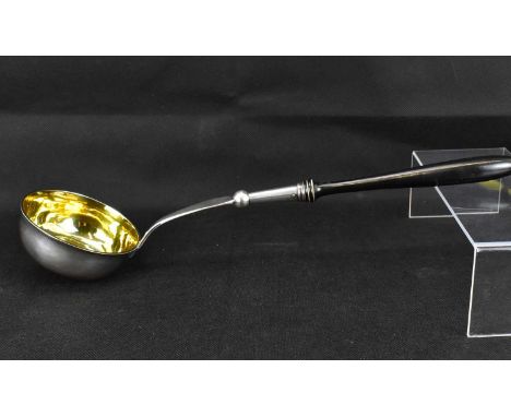 A silver soup ladle with gilt inner bowl, pin dot initials 'JAR' over 'CR' to the lower handle and turned wooden handle, Geor