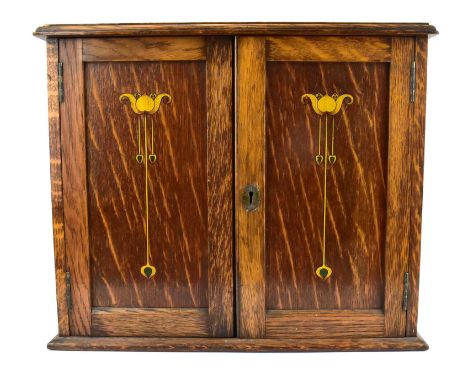 An early 20th century oak tabletop smokers' cabinet with small brass presentation plaque to the top, Art Nouveau inset design