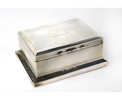 A hallmarked silver engine turned cigarette box with vacant cartouche, marks rubbed, 5 x 13.5 x 9cm.