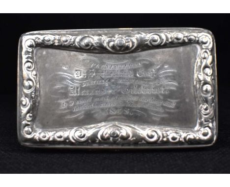 A Victorian hallmarked silver snuff box with raised floral border to the lid with inscription 'Presented by D. Sutherland Esq