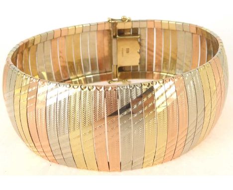 A 9ct gold three-colour semi-rigid bracelet with engine turned detail, united with a box clasp and safety lock, length 18cm, 