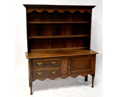 A Georgian-style oak dresser with enclosed plate rack above a base of two drawers with a cupboard door, on turned tapering le