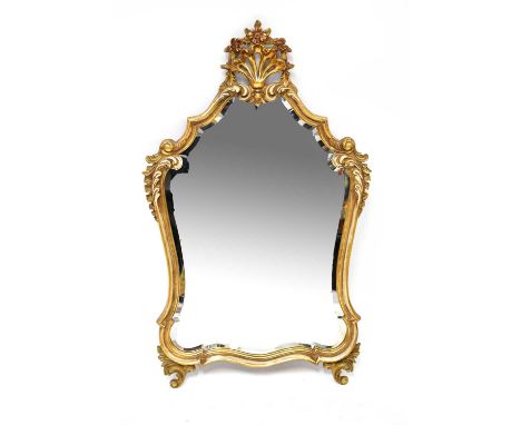 A 20th century Rococo-style gilded wall mirror with large shell and floral finial to the top and acanthus leaf decoration thr