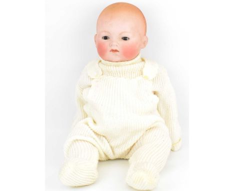An early 20th century bisque head doll with sleepy eyes, closed mouth and bald head, with composite body and limbs, unmarked,
