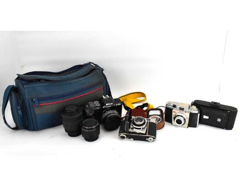 A Nikon F-401S camera and lens, a Sigma UC zoom 70-210mm multi-coated lens, a 2x NAS Teleplus MC7 flash, straps and camera ca