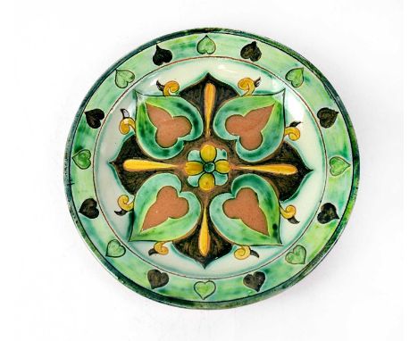 DELLA ROBBIA; an early 20th century plate, with green and brown ground and abstract leaf decoration, central floral image wit