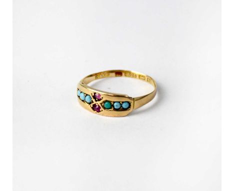 A 15ct yellow gold ring set with six small turquoise and two red stones, size M 1/2, approx. 1.5g.