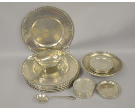 Pewter dishes of various sizes, sauceboat and ladle,