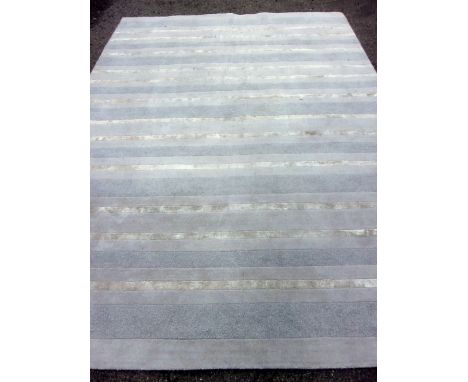 Calvin Klein carpet with blues and silver bands, 131cm x 236cmDirty overall, wear to the edges.Sahara Mercury80% wool 20% vis