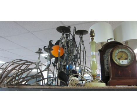 Collection of candleholders, lamps, three clocks and an aneroid barometer,