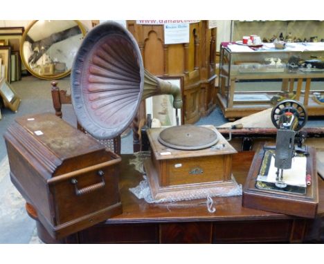A "Sterno" wind up gramophone, together with a manual Singer sewing machine in case (2)