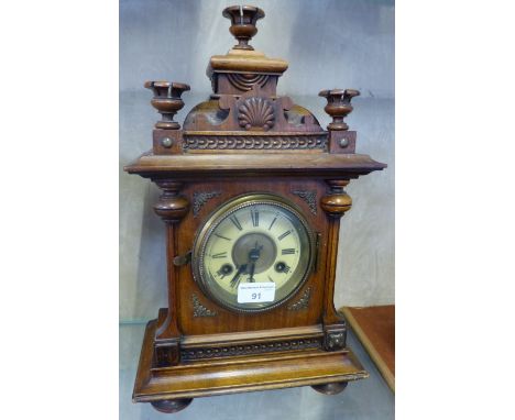 A late 19th century walnut mantel clock. Striking on a bell. Height 42cm