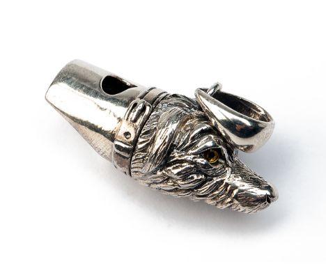A STERLING SILVER DOG WHISTLE, marked 'STERLING', with glass eyes and lanyard ring, measuring approx. 1in..    