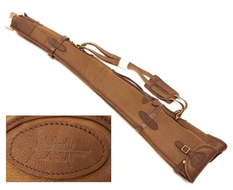 JOANNE YORATH A CHESTNUT LEATHER FLEECE-LINED DOUBLE GUNSLIP, with leather shoulder strap and brass fittings.    ï¾† Please n