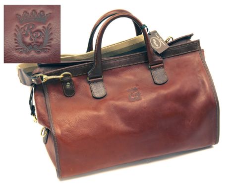 RAY PAVON A FINE NEW AND UNUSED LEATHER ROMERO TRAVEL BAG, with brown and beige canvas lining leather carry handle, clip-on c