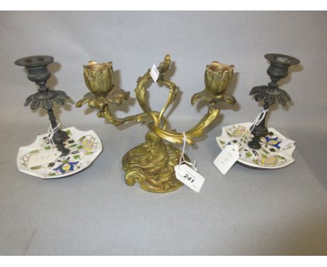 Pair of patinated metal and porcelain chamber candlesticks, together with a French ormolu two branch candelabra