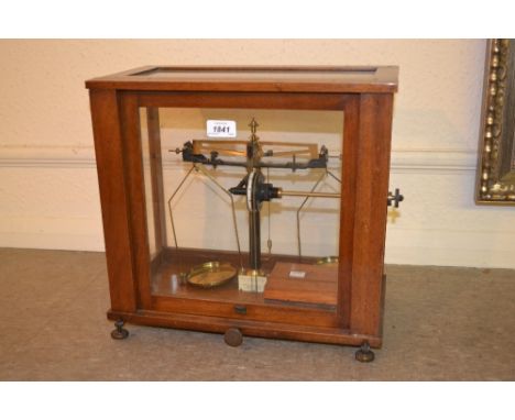 Cased pair of brass and black anodised laboratory balance scales with weights