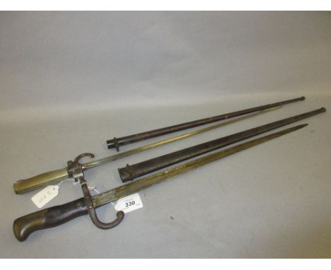 French 1875 pattern bayonet with scabbard together with a French 1886 bayonet with scabbard