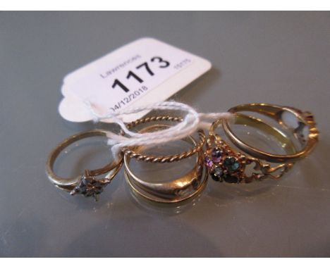 Four various dress rings including an opal and diamond ring, together with two gold bands