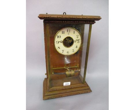 Horo - Electriques clock, the white enamel chapter ring enclosing a skeletonised movement, in a glazed wooden case