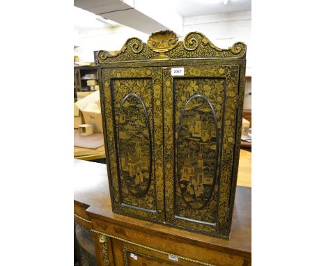 19th Century Chinese export lacquer table cabinet, the shaped shell and scroll cornice above a pair of oval panelled doors de