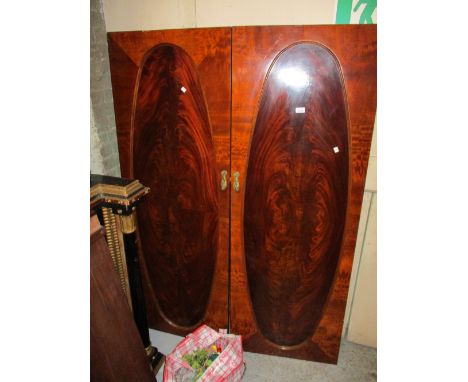 Good quality early 20th Century mahogany compactum type wardrobe, the moulded cornice above a pair of oval figured panelled d